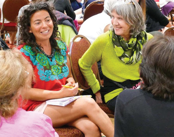 4 women talking smiling